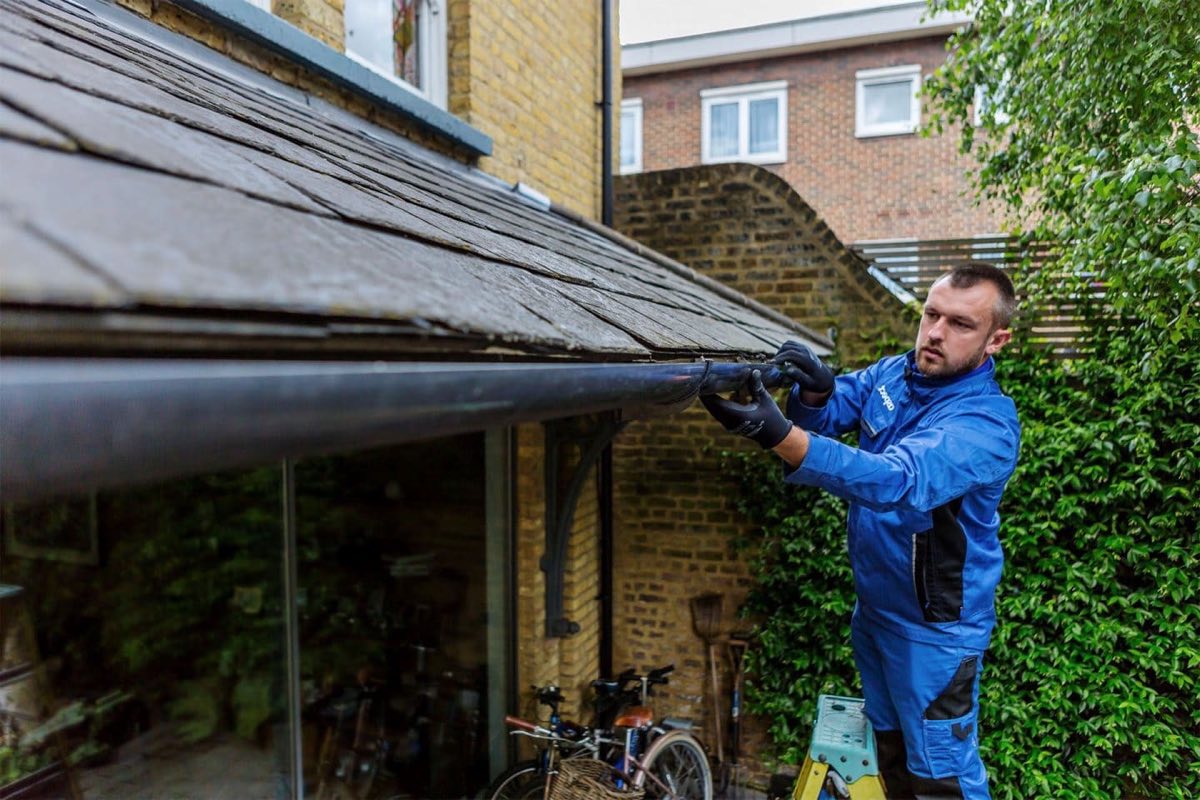 White guttering and downpipe fitted along a residential roofline