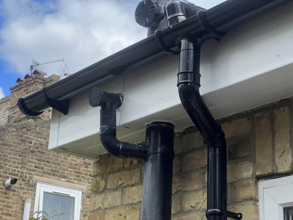 Black guttering and connected downpipe