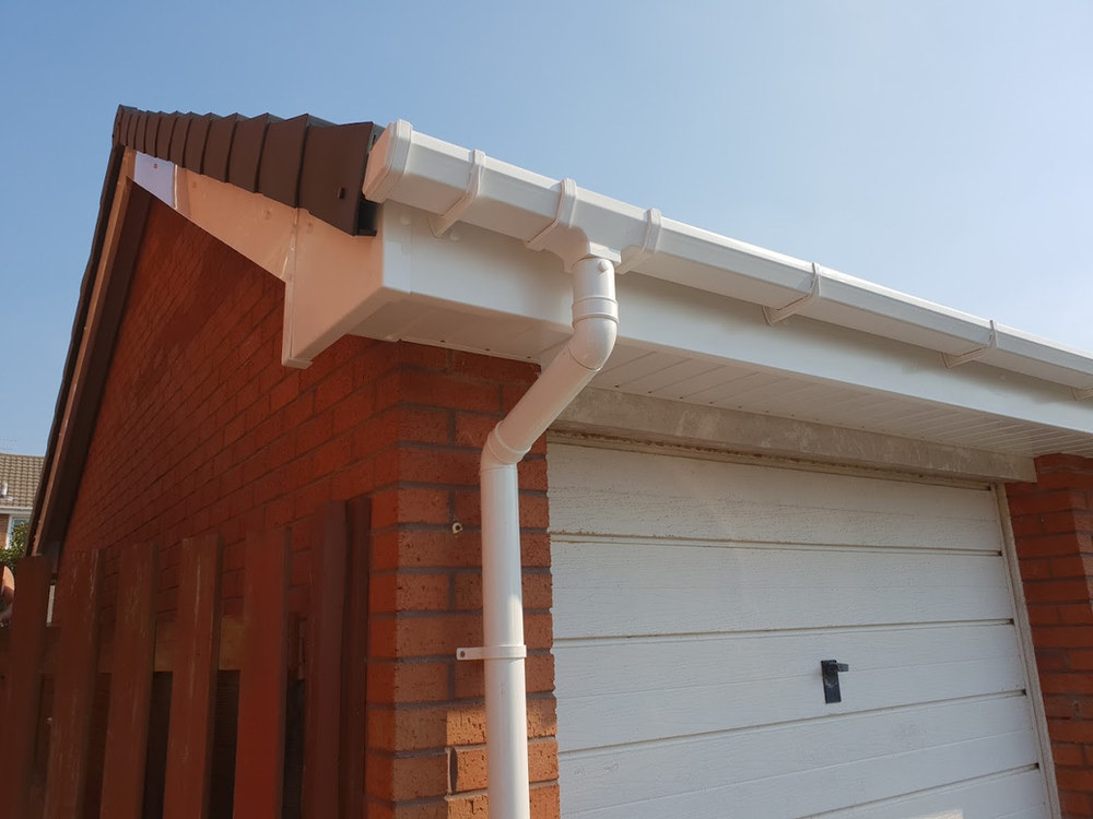Replacement white guttering and downpipe on a home